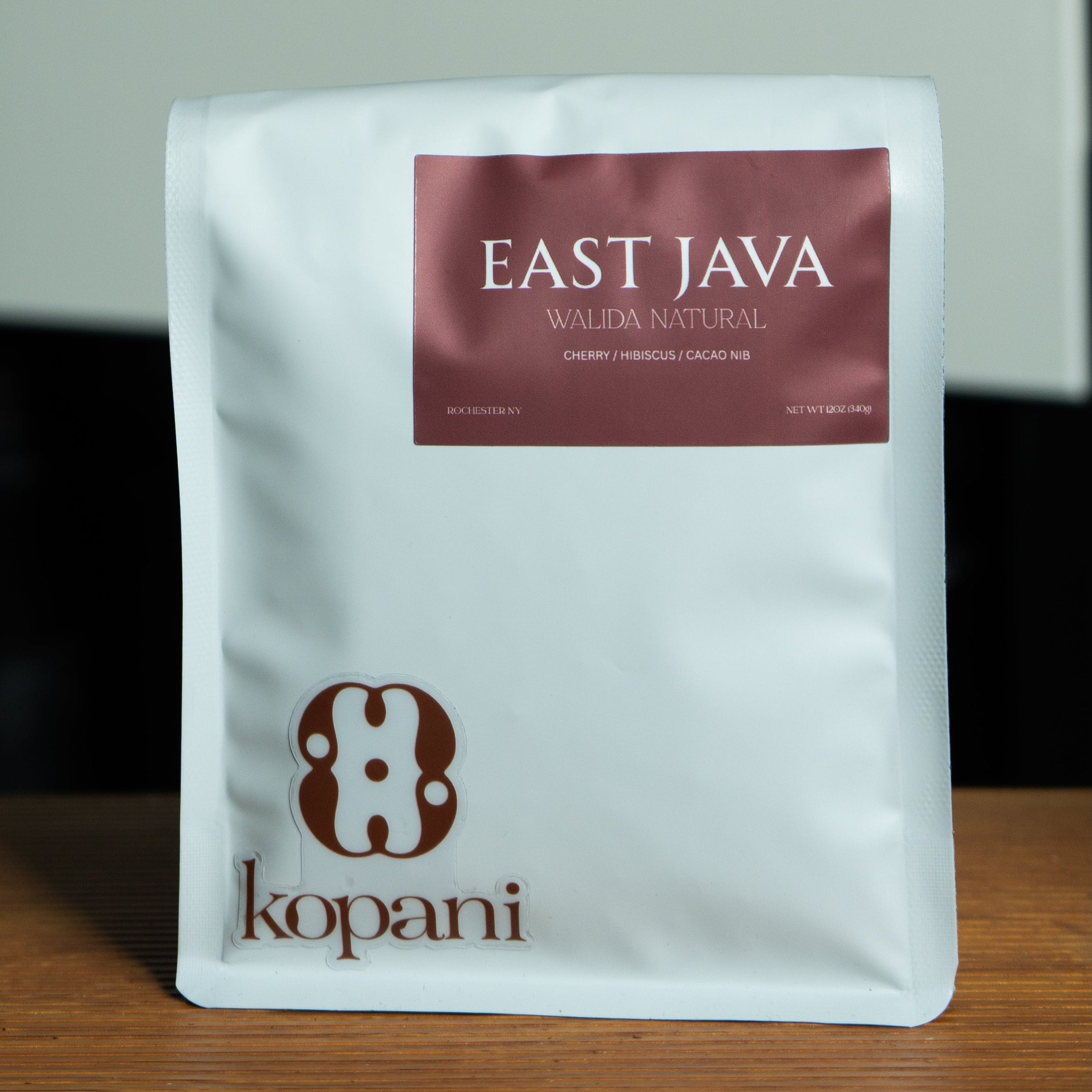 Kopani East Java coffee package on a wooden surface with a blurred background